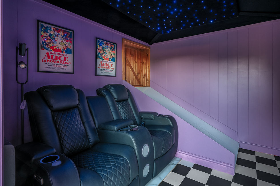 cinema room with reclining seats and star-effect ceiling at Alice’s Secret Garden