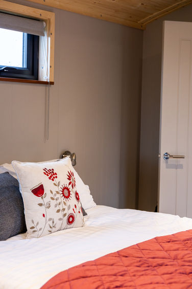 king size bed inside shepherd's hut glamping lancashire