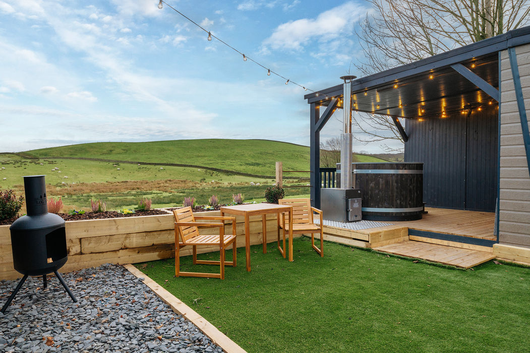 Outdoor hot tub with breathtaking countryside views at Hidden Hills luxury glamping