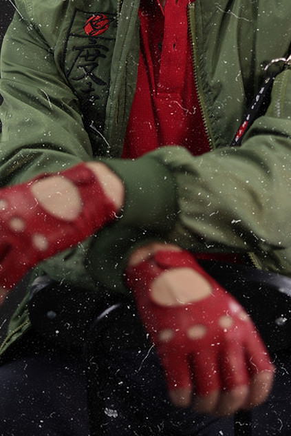 Retro film grain photo of red automotive racing gloves with a green car club jacket