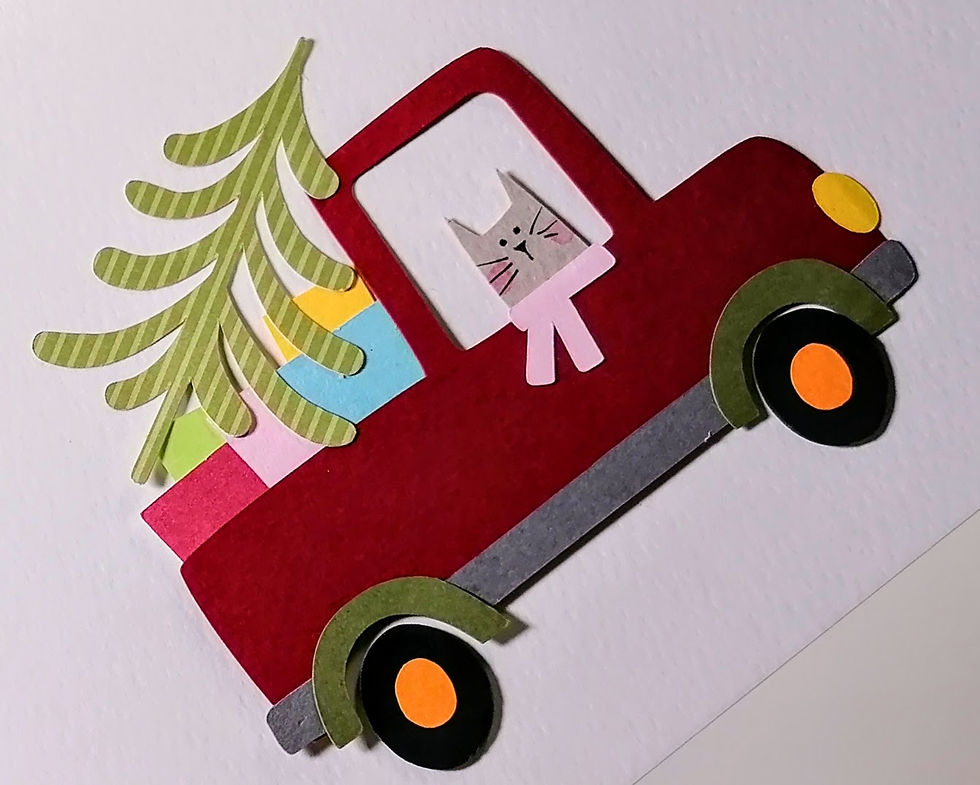 Red pickup truck with Christmas tree, presents, and a cat
