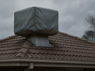 A covered evaporative cooler on a rooftop