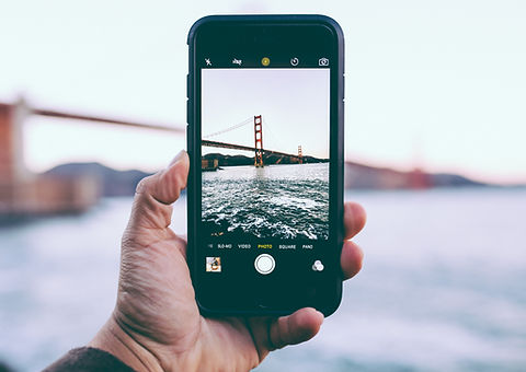 Holding iPhone camera up to Golden Gate bridge in San Francisco