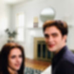 Bella and Edwards standing in the living room and smiling
