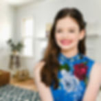 Renesmee standing in the lounge room and smiling
