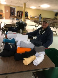 Another volunteer sorting clothing