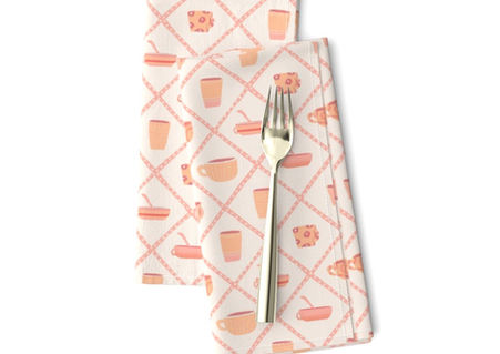 A slightly creased piece of fabric featuring a design of a peach and salmon colored crockery cups framed by a diamond lattice by lenes_linien