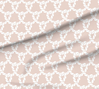 A slightly creased piece of fabric featuring white ropes forming an interlocking nautical knot design on a blush pink ground by lenes_linien.