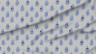 A slightly creased piece of fabric showing a gender-neutral design of raindrop characters with funny faces in blue on light gray.