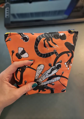 A slightly creased piece of fabric showing an art nouveau inspired frog pond design with fluid lines by lenes_linien