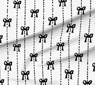 A slightly creased piece of fabric featuring a design  of white hand-drawn bows on black texture by lenes_linien