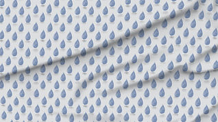 A slightly creased piece of fabric showing a simple design of muted blue raindrops with dropshadows on light gray ground.