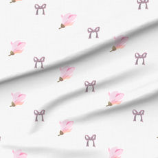 A slightly creased piece of fabric featuring a design of regularly spaced single magnolia flowers on faux-linen texture by lenes_linien