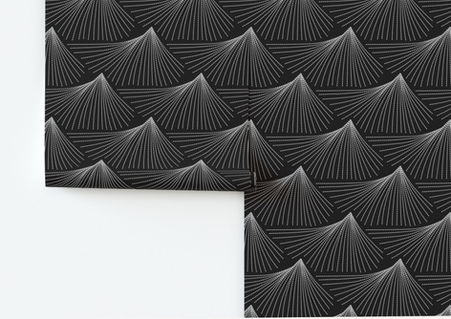 A slightly creased piece of fabric featuring abstract faux-embroidery mountaintops in white and gray on a black field by lenes_linien.