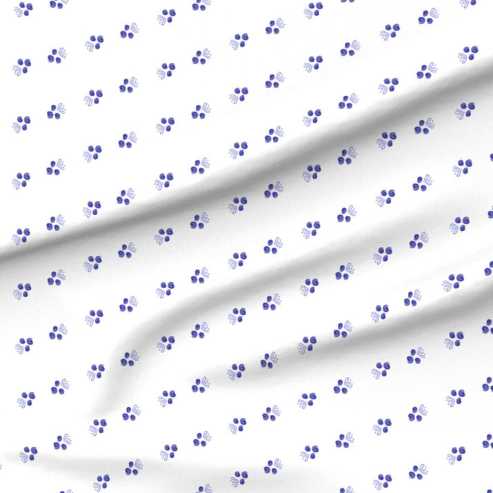 A slightly creased piece of fabric featuring a design of abstracted blueberry pairs facing in diagonal lines on white by lenes_linien