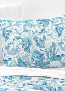 A slightly creased piece of fabric featuring lobsters crabs corals kelp and seaweed in serene blue tones by lenes_linien.