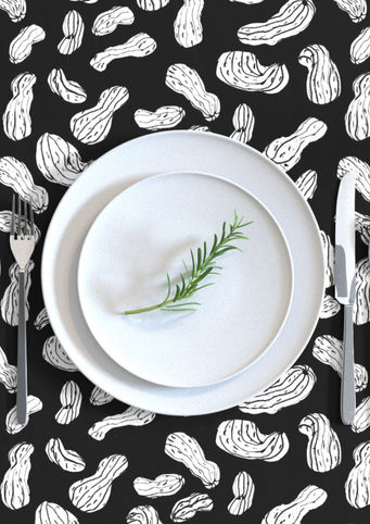 A slightly creased piece of fabric showing a modern blockprint style design of hand-drawn peanut shapes by lenes_linien