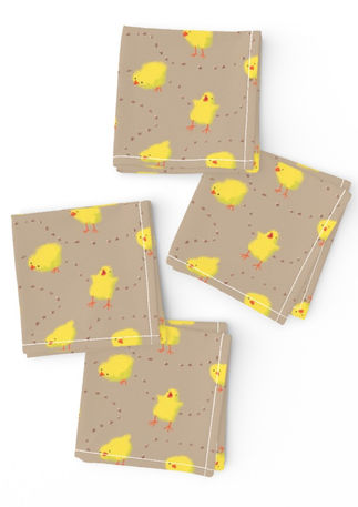 A slightly creased piece of fabric featuring fluffy yellow chicks and scattered corn kernels on a warm taupe background by lenes_linien.