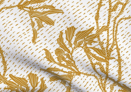 A slightly creased piece of fabric featuring an elegant duotone design of sea kelp fronds in a blockprint style.