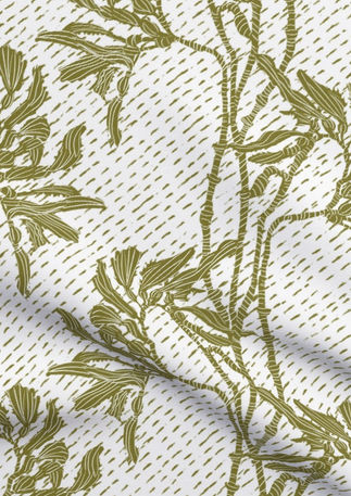 A slightly creased piece of fabric featuring an elegant duotone design of sea kelp fronds in a blockprint style.