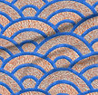 A slightly creased piece of fabric featuring Seigaiha wave scallops with a coral marble texture in cobalt blue and terracotta orange by lenes_linien.