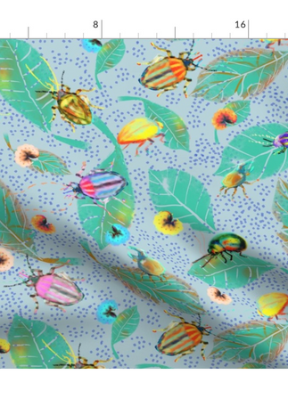 A slightly creased rectangle of fabric showing colorful bugs against pristine white background structured by light blue clustered dots.