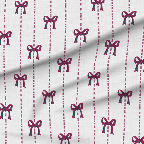A slightly creased piece of fabric featuring a design  of hand-drawn burgundy bows and dashed stripes on white by lenes_linien