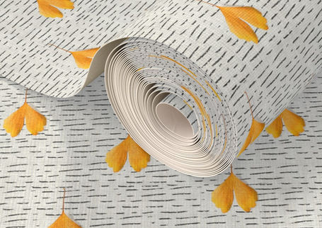 A slightly creased piece of fabric featuring falling yellow ginkgo leaves on a white-grayish background with black dashed lines by lenes_linien.