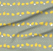 A slightly creased piece of fabric featuring a design of yellow tiny chicklets picking a grid formed of kernels by lenes_linien