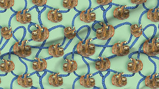 A slightly creased piece of fabric featuring the described design of hand-drawn sloths hanging on lianas.