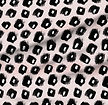 A slightly creased piece of fabric featuring abstract leopard spots in black and white on a soft pink knitted texture by lenes_linien.
