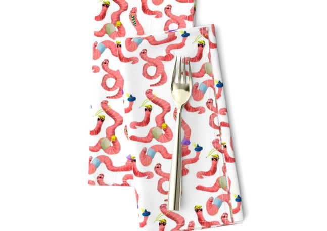 A slightly creased rectangle of fabric showing a lenes_linien design of fun ogee-shaped clusters of characterful earthworms on a unicolored background.