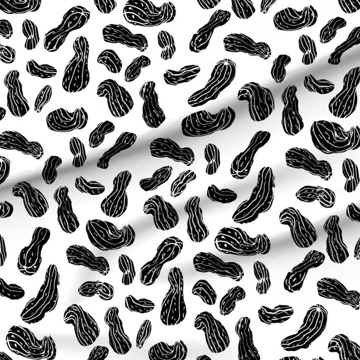 A slightly creased piece of fabric showing a modern blockprint style design of hand-drawn peanut shapes by lenes_linien