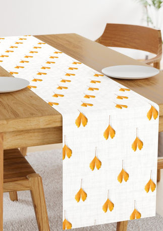 A slightly creased piece of fabric featuring scattered golden ginkgo leaves on white-grayish texture by lenes_linien.