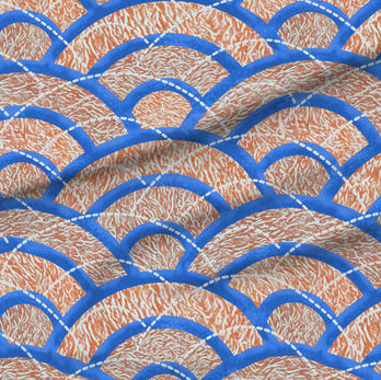 A slightly creased piece of fabric featuring traditional Japanese Seigaiha waves with coral marble texture in blue and orange by lenes_linien.