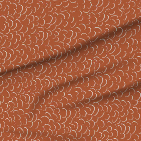 A slightly creased piece of fabric featuring abstract crescent shapes on an earthy orange ground by lenes_linien.