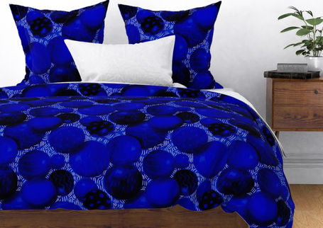 A slightly creased piece of fabric showing a design of intersecting ornamental circles framed by scattered stitches.