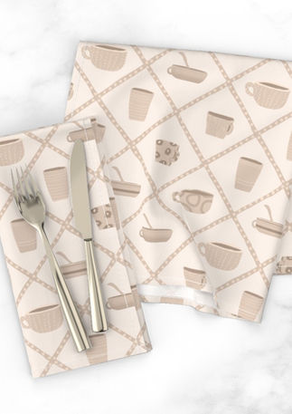 A slightly creased piece of fabric featuring a design of a creamy beige colored crockery cups framed by a diamond lattice by lenes_linien