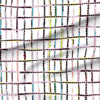 A slightly creased piece of fabric featuring punky colorful zigzag trimmings arranged in grid format on white.