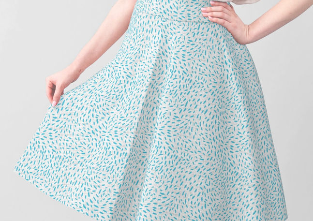 A slightly creased piece of fabric featuring small aqua blue dashes creating an abstract whirl composition by lenes_linien.