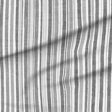 A slightly creased piece of fabric featuring hand-painted irregular vertical stripes in grayscale tones by lenes_linien.