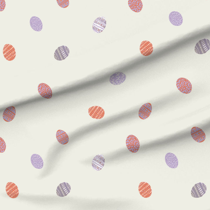 A slightly creased piece of fabric featuring tossed small decorated easter eggs.