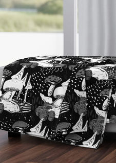 A slightly creased piece of fabric featuring stylized mushrooms and fungi in black and white tones by lenes_linien.