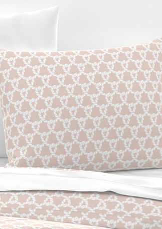 A slightly creased piece of fabric featuring white ropes forming an interlocking nautical knot design on a blush pink ground by lenes_linien.