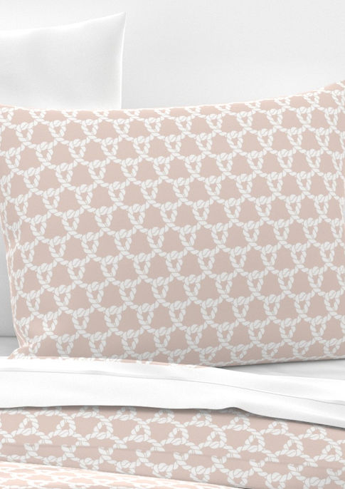 A slightly creased piece of fabric featuring white ropes forming an interlocking nautical knot design on a blush pink ground by lenes_linien.