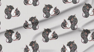 A slightly creased piece of fabric featuring rats tumbling about and cuddling each other.