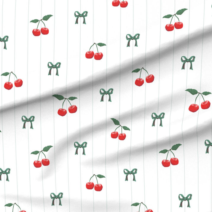 A slightly creased piece of fabric featuring a design of red cherries with green stems and Stripes on White by lenes_linien