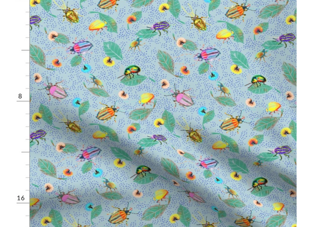 A slightly creased rectangle of fabric showing colorful bugs against muted light blue background structured by light blue clustered dots.