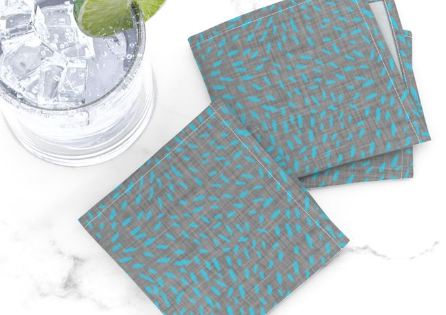 A slightly creased piece of fabric featuring abstract dashes and scattered brush strokes in aqua blue and stone gray by lenes_linien.