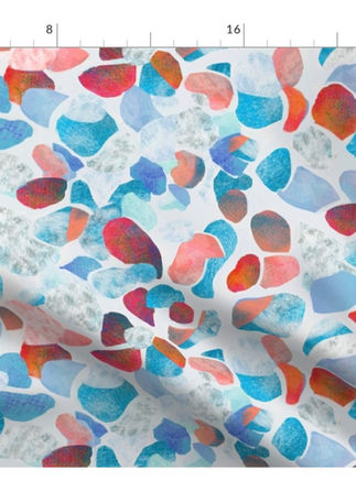 A slightly creased piece of fabric featuring abstract, textured shapes resembling mediterranean terrazzo stone floors.